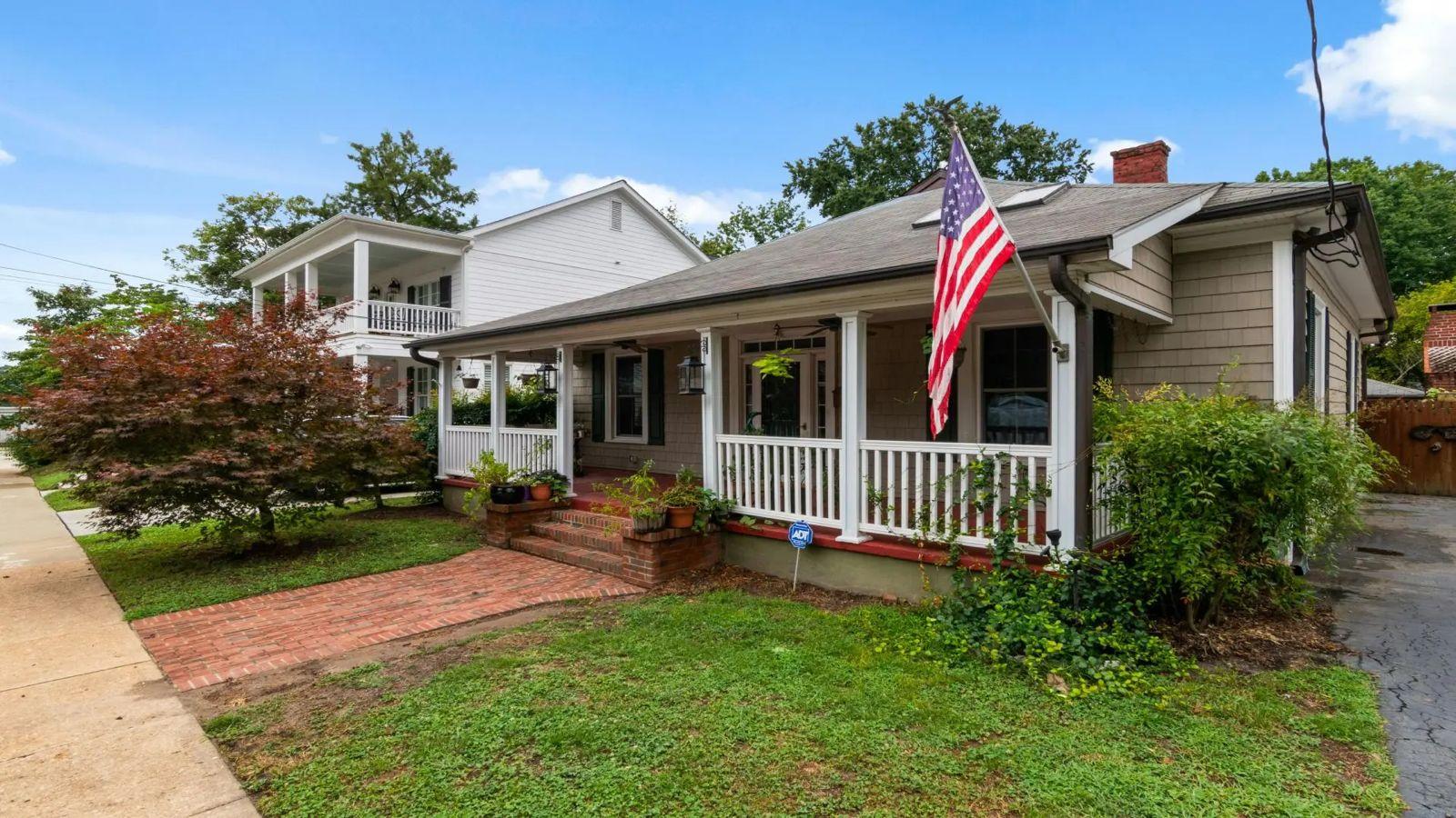 American home with a front porch and flag